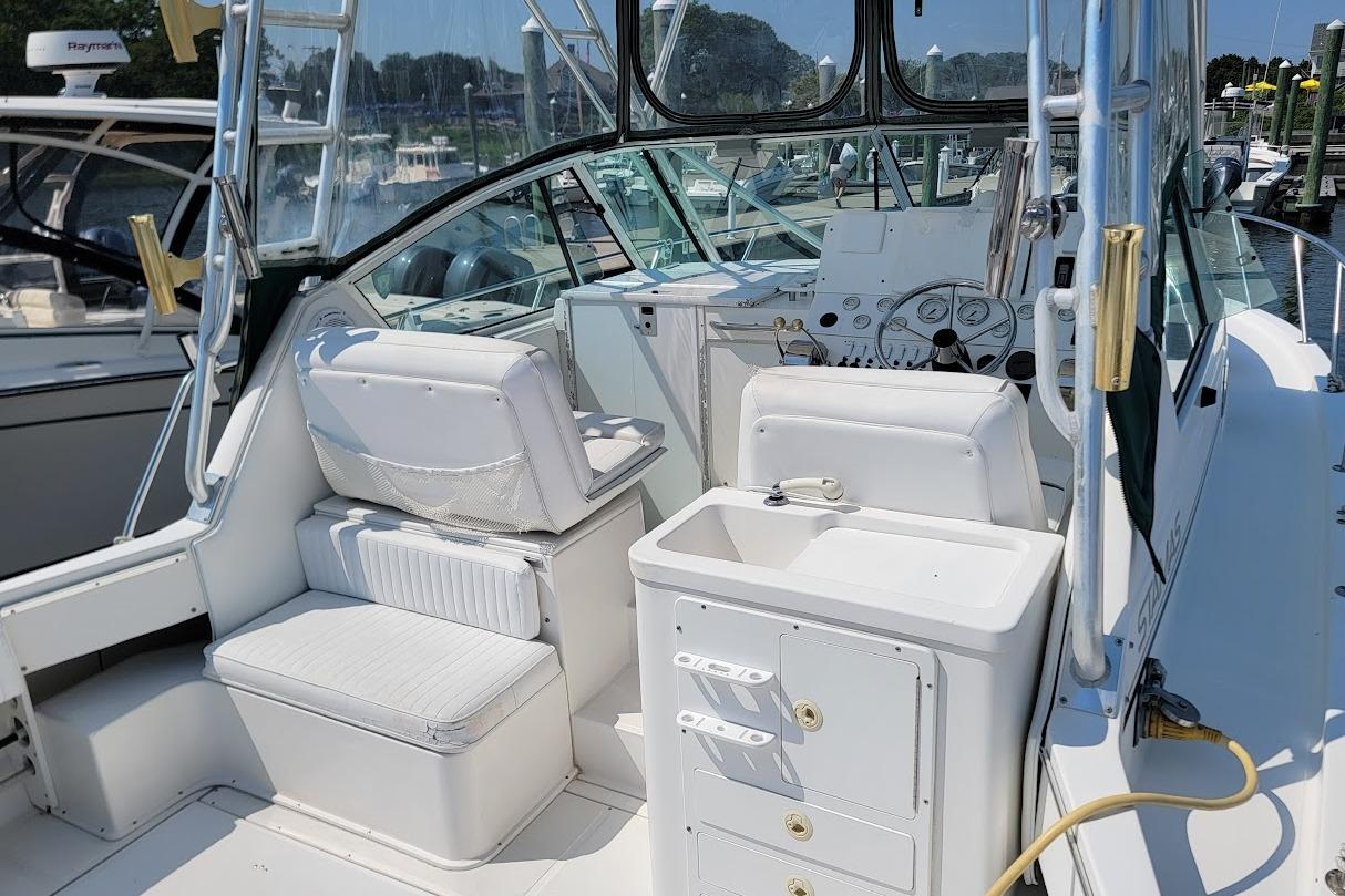 2000 Stamas 310 Express boat interior with seating and control panel.