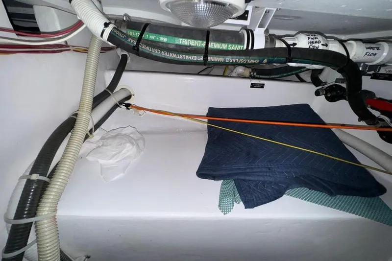 Miss Maggie Yacht Photos Pics Engine room of 2002 Viking 61 Enclosed Bridge with hoses and folded blankets.