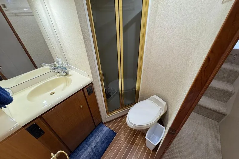 Miss Maggie Yacht Photos Pics Bathroom interior of 2002 Viking 61 Enclosed Bridge yacht with shower and toilet.