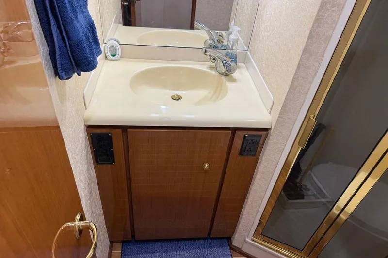 Miss Maggie Yacht Photos Pics Bathroom vanity and shower in 2002 Viking 61 Enclosed Bridge yacht.