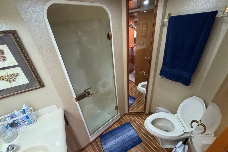 Miss Maggie Yacht Photos Pics Bathroom interior of 2002 Viking 61 Enclosed Bridge yacht with shower and toilet.