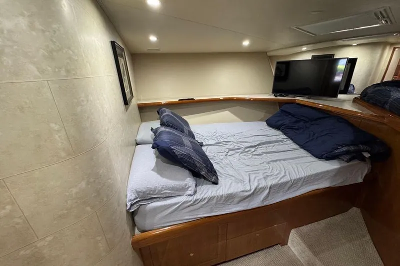 Miss Maggie Yacht Photos Pics Cozy bedroom interior of 2002 Viking 61 Enclosed Bridge yacht with modern amenities.