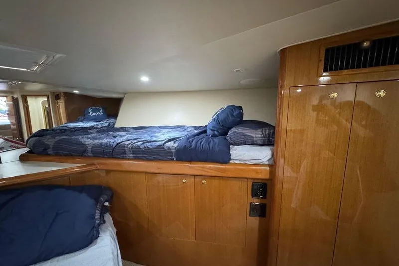 Miss Maggie Yacht Photos Pics Cozy cabin interior of 2002 Viking 61 Enclosed Bridge yacht with wooden finishes.