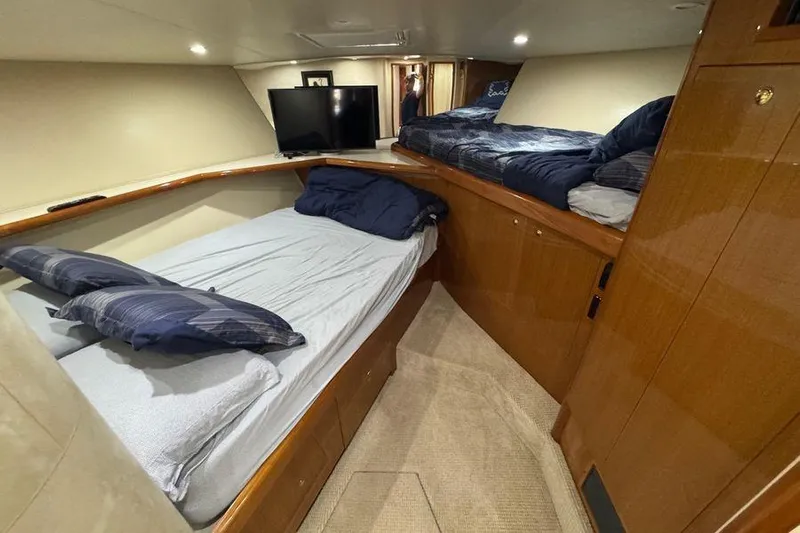 Miss Maggie Yacht Photos Pics Interior cabin of 2002 Viking 61 Enclosed Bridge yacht with twin beds and TV.