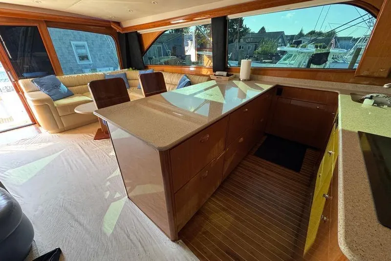 Miss Maggie Yacht Photos Pics Luxurious interior of 2002 Viking 61 Enclosed Bridge yacht with spacious seating and modern kitchen.