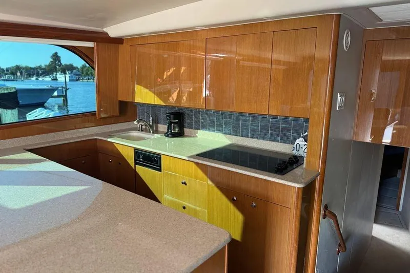 Miss Maggie Yacht Photos Pics Luxurious kitchen interior of 2002 Viking 61 Enclosed Bridge yacht with wood cabinetry.