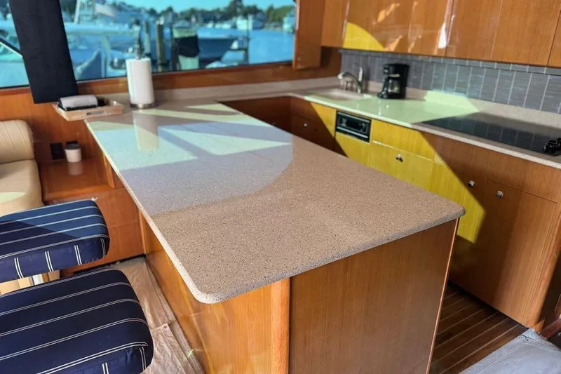 Miss Maggie Yacht Photos Pics Luxurious kitchen interior of 2002 Viking 61 Enclosed Bridge yacht with modern amenities.
