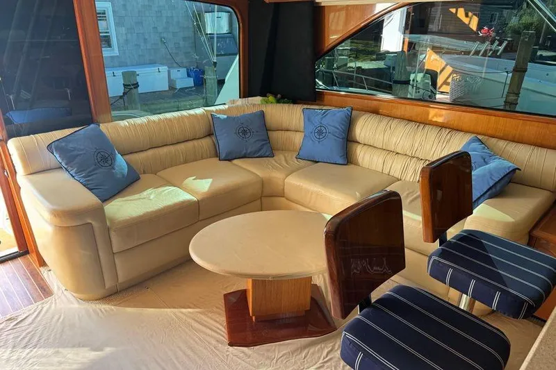 Miss Maggie Yacht Photos Pics Luxurious interior of 2002 Viking 61 Enclosed Bridge yacht with plush seating and elegant decor.
