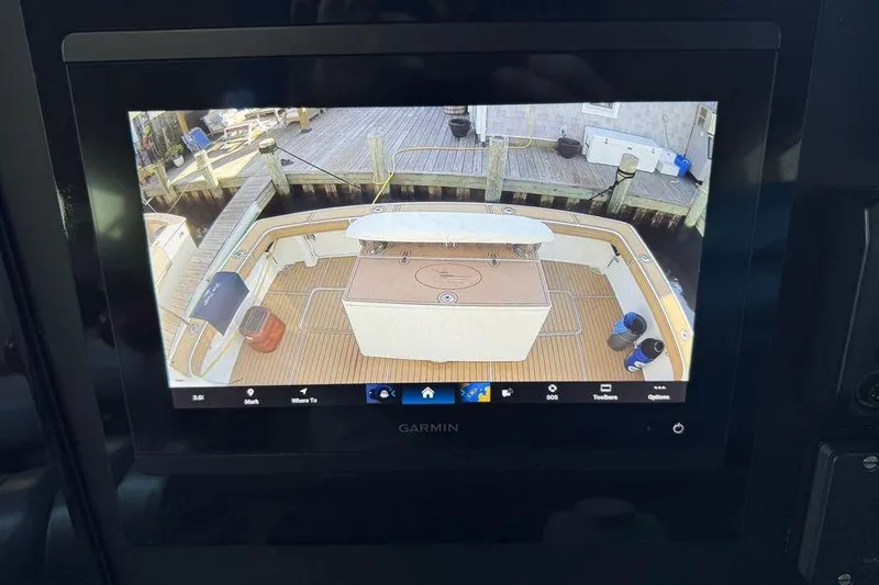 Miss Maggie Yacht Photos Pics Garmin display showing 2002 Viking 61 Enclosed Bridge yacht deck view at dock.