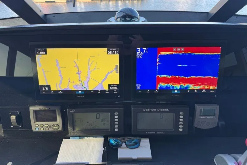 Miss Maggie Yacht Photos Pics Control panel of a 2002 Viking 61 Enclosed Bridge with navigation and sonar displays.