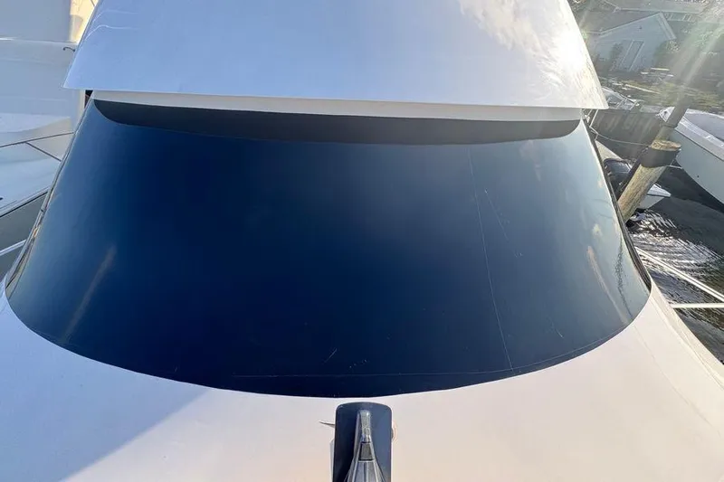 Miss Maggie Yacht Photos Pics 2002 Viking 61 Enclosed Bridge yacht with sleek tinted windows.