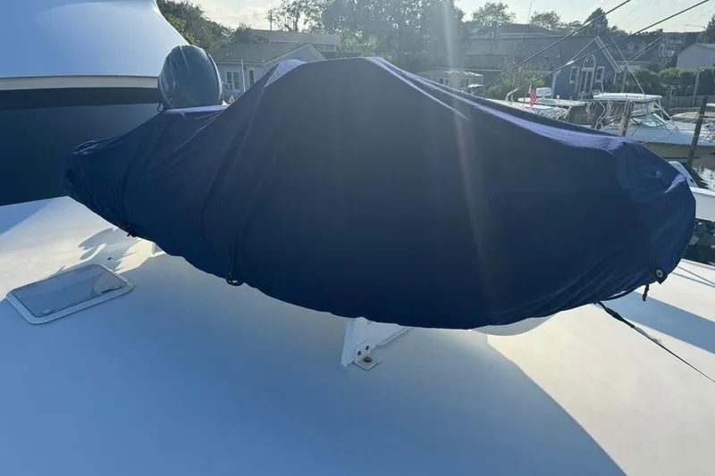 Miss Maggie Yacht Photos Pics Covered equipment on 2002 Viking 61 Enclosed Bridge yacht deck, sunny day.