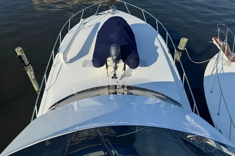 Miss Maggie Yacht Photos Pics 2002 Viking 61 Enclosed Bridge yacht docked, aerial view of bow and deck.