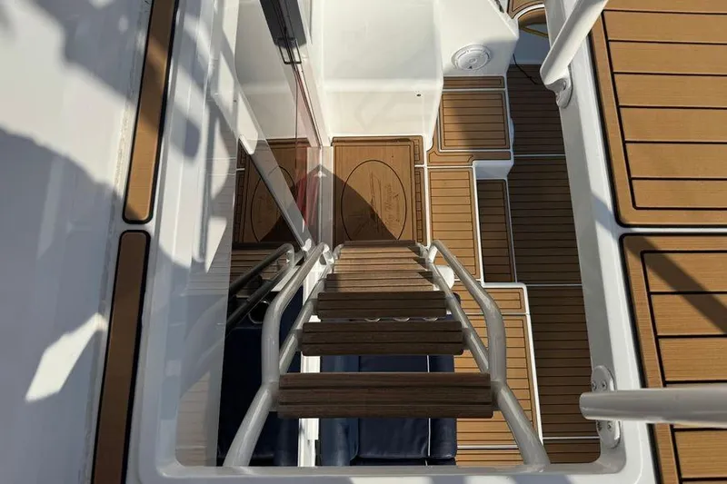 Miss Maggie Yacht Photos Pics Staircase view on 2002 Viking 61 Enclosed Bridge yacht with teak flooring.