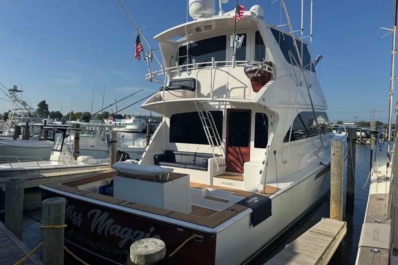 Miss Maggie Yacht Photos Pics 2002 Viking 61 Enclosed Bridge yacht docked at marina under clear blue sky.