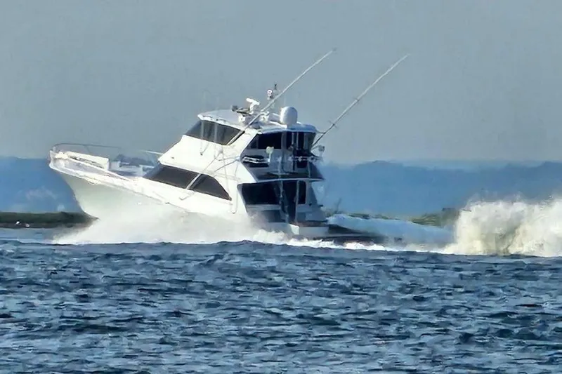 Miss Maggie Yacht Photos Pics 2002 Viking 61 Enclosed Bridge yacht cruising on open water.