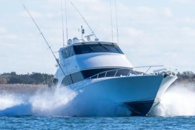 Miss Maggie Yacht Photos Pics 2002 Viking 61 Enclosed Bridge yacht cruising on open water.