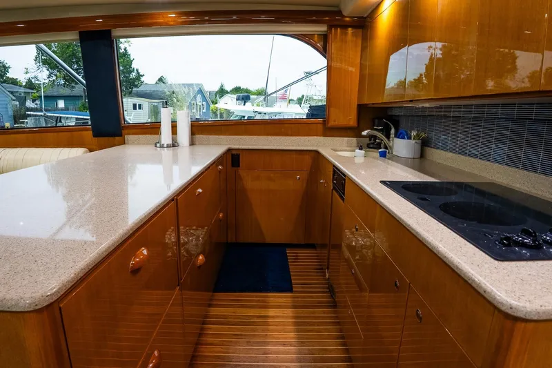 Miss Maggie Yacht Photos Pics Luxurious kitchen interior of 2002 Viking 61 Enclosed Bridge yacht with modern amenities.
