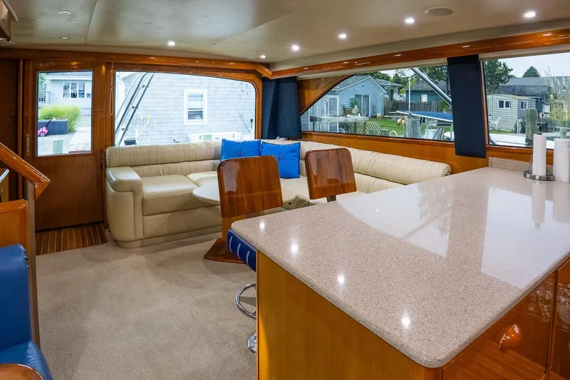 Miss Maggie Yacht Photos Pics Luxurious interior of 2002 Viking 61 Enclosed Bridge yacht with elegant seating and modern design.