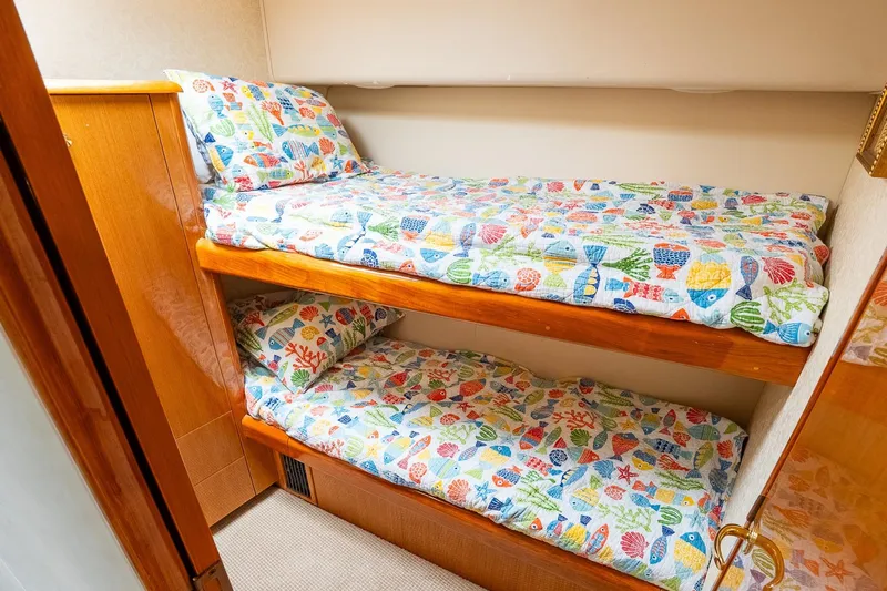 Miss Maggie Yacht Photos Pics Bunk beds with colorful fish-themed bedding in 2002 Viking 61 Enclosed Bridge yacht.