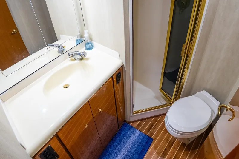 Miss Maggie Yacht Photos Pics Bathroom interior of 2002 Viking 61 Enclosed Bridge yacht with shower, sink, and toilet.