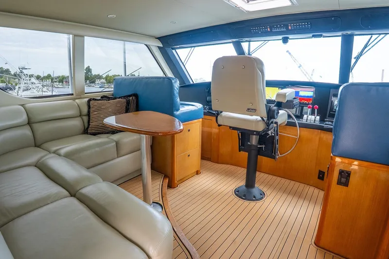 Miss Maggie Yacht Photos Pics Luxurious interior of 2002 Viking 61 Enclosed Bridge yacht with leather seating and navigation controls.