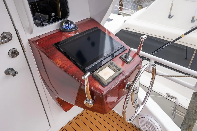 Miss Maggie Yacht Photos Pics Control panel of 2002 Viking 61 Enclosed Bridge yacht with steering wheel and navigation equipment.