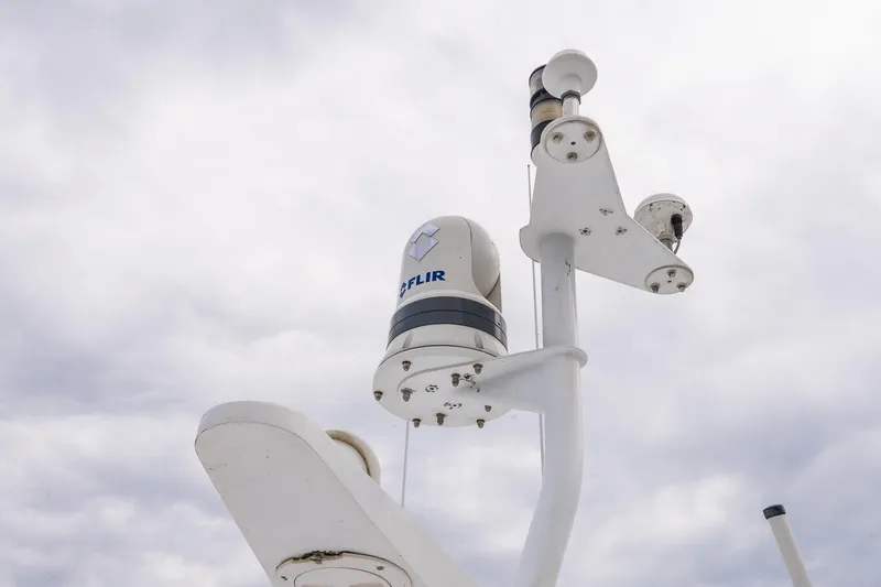 Miss Maggie Yacht Photos Pics Radar and camera equipment on 2002 Viking 61 Enclosed Bridge yacht against cloudy sky.
