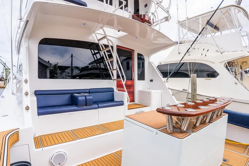 Miss Maggie Yacht Photos Pics 2002 Viking 61 Enclosed Bridge yacht with sleek seating and fishing rod holders.