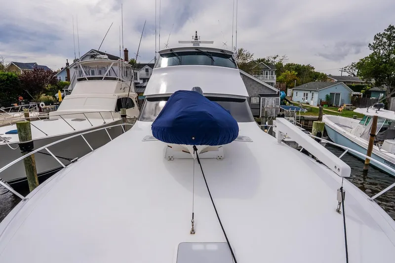 Miss Maggie Yacht Photos Pics 2002 Viking 61 Enclosed Bridge yacht docked, showcasing sleek design and spacious deck.