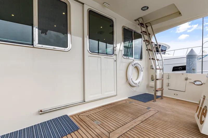 Tumbleweed Yacht Photos Pics 2016 North Pacific 49 Pilothouse yacht deck with ladder and life preserver.