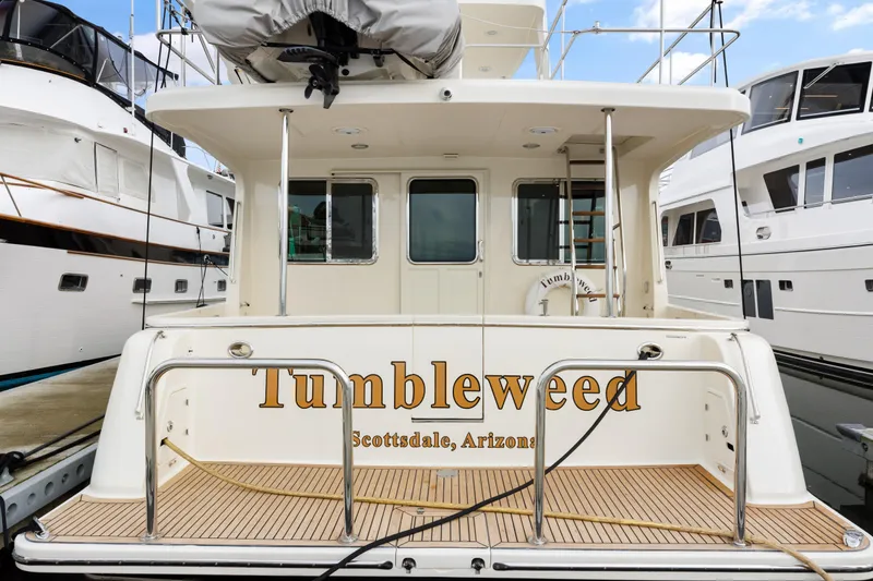 Tumbleweed Yacht Photos Pics North Pacific 49 Pilothouse 2016 yacht "Tumbleweed" docked, rear view with Scottsdale, Arizona signage.