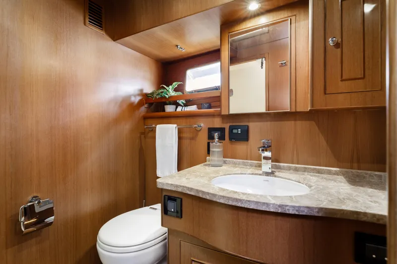 Tumbleweed Yacht Photos Pics Luxurious 2016 North Pacific 49 Pilothouse bathroom with wood finish and modern fixtures.