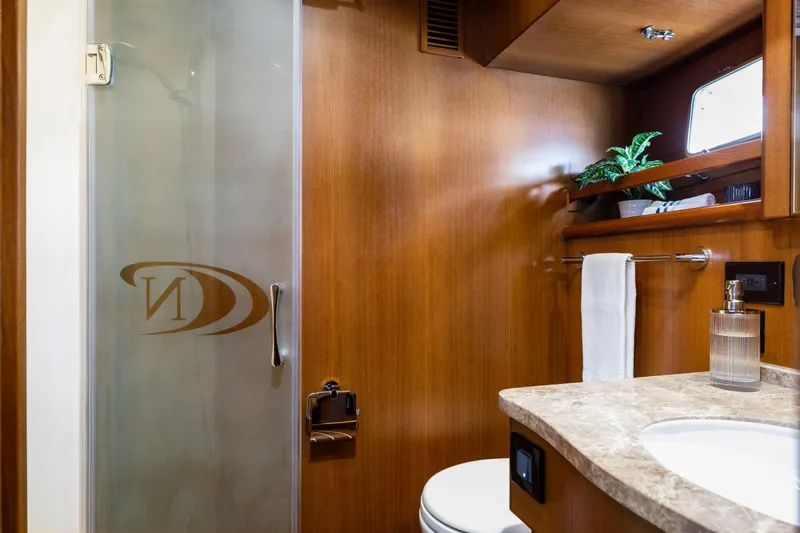 Tumbleweed Yacht Photos Pics Luxurious bathroom in 2016 North Pacific 49 Pilothouse yacht with wood accents and modern fixtures.