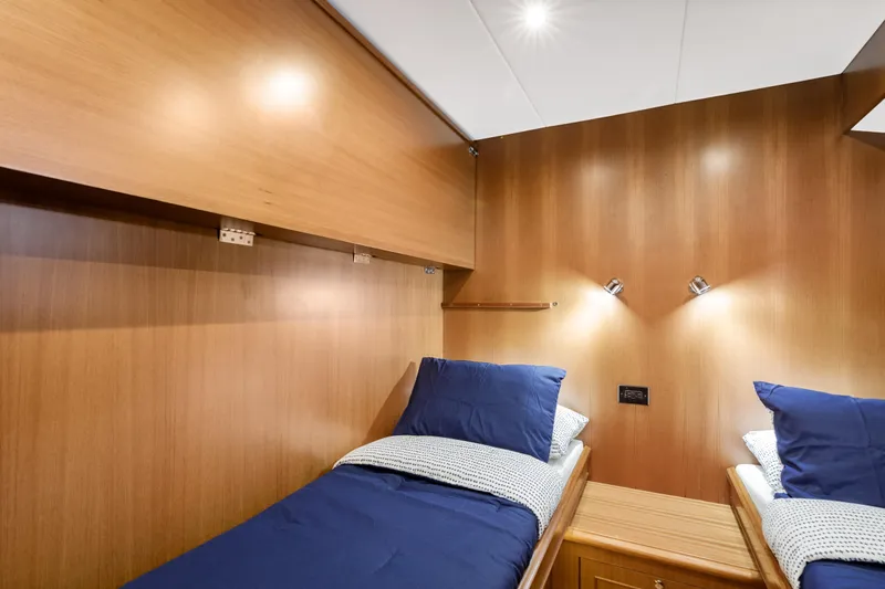 Tumbleweed Yacht Photos Pics Twin cabin with blue bedding in 2016 North Pacific 49 Pilothouse yacht.
