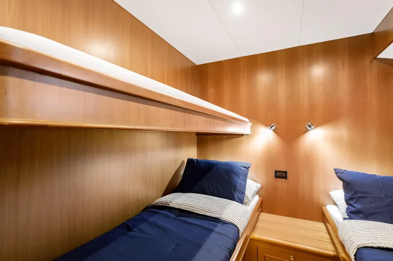 Tumbleweed Yacht Photos Pics 2016 North Pacific 49 Pilothouse cabin with twin beds and wooden interior.