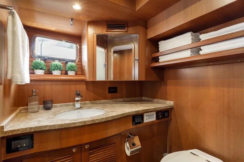 Tumbleweed Yacht Photos Pics Luxurious bathroom in 2016 North Pacific 49 Pilothouse yacht with wood finish and modern amenities.