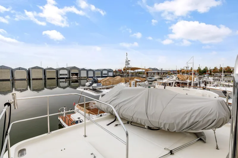 Tumbleweed Yacht Photos Pics 2016 North Pacific 49 Pilothouse yacht docked at marina with covered equipment.