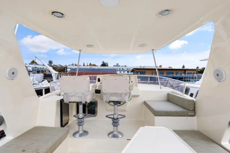 Tumbleweed Yacht Photos Pics 2016 North Pacific 49 Pilothouse boat interior with seating and helm chairs.