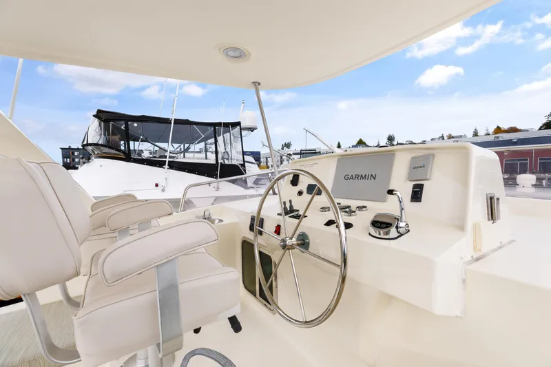 Tumbleweed Yacht Photos Pics Pilothouse of 2016 North Pacific 49, featuring Garmin navigation, docked in marina.