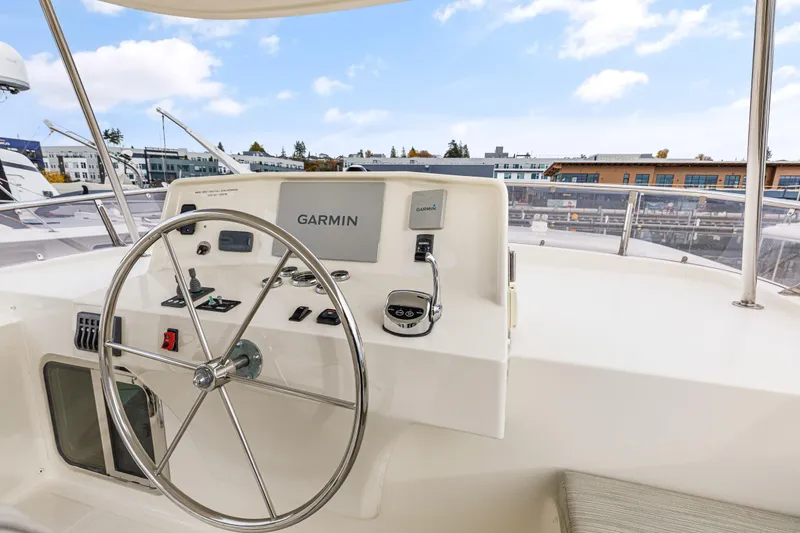 Tumbleweed Yacht Photos Pics 2016 North Pacific 49 Pilothouse helm with Garmin navigation system and steering wheel.