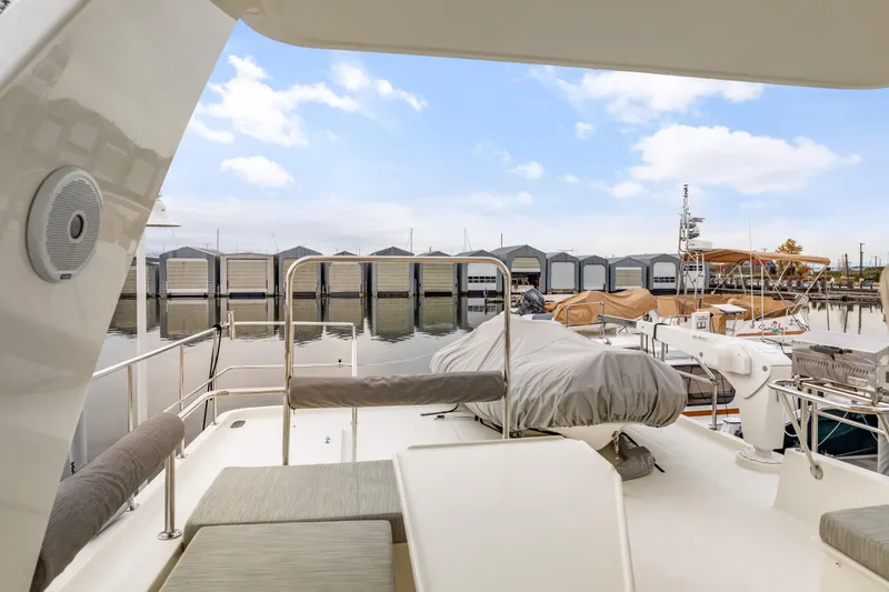 Tumbleweed Yacht Photos Pics 2016 North Pacific 49 Pilothouse yacht docked at marina with covered seating area.