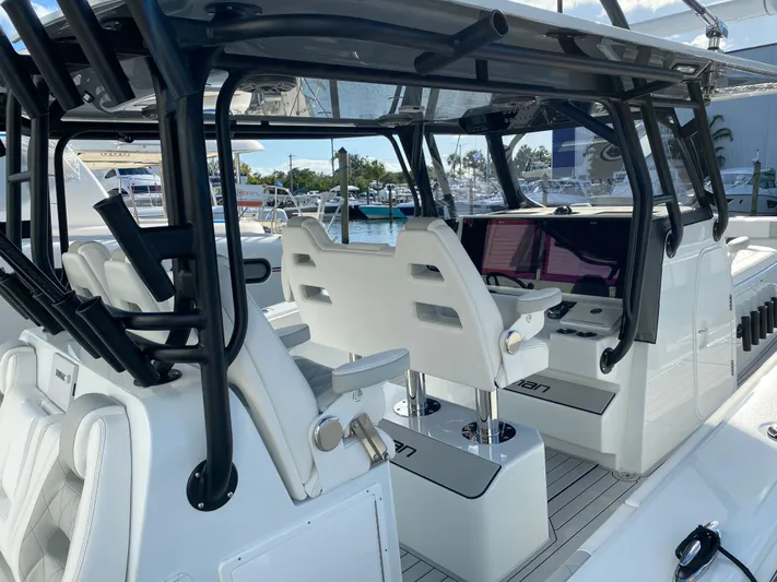  Yacht Photos Pics Interior view of a 2021 Freeman 42 LR boat with modern seating and controls.