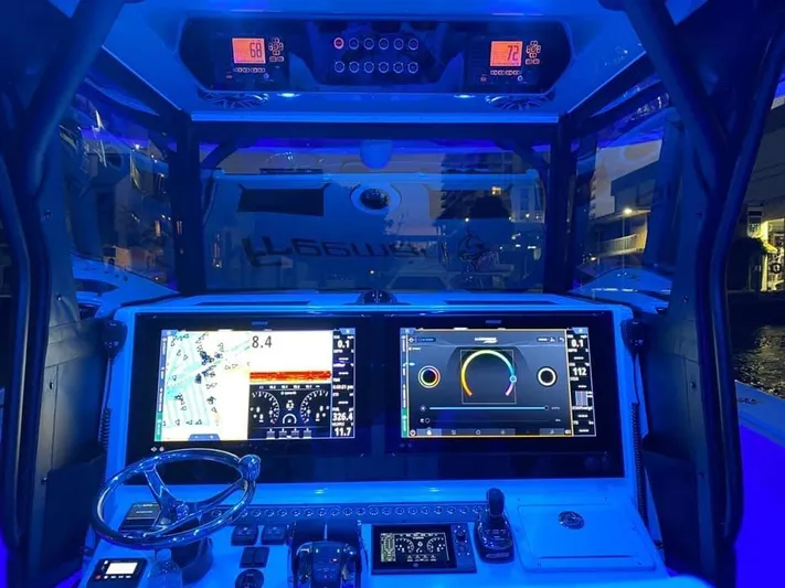  Yacht Photos Pics Freeman 42 LR 2021 boat cockpit with illuminated navigation screens and controls at night.