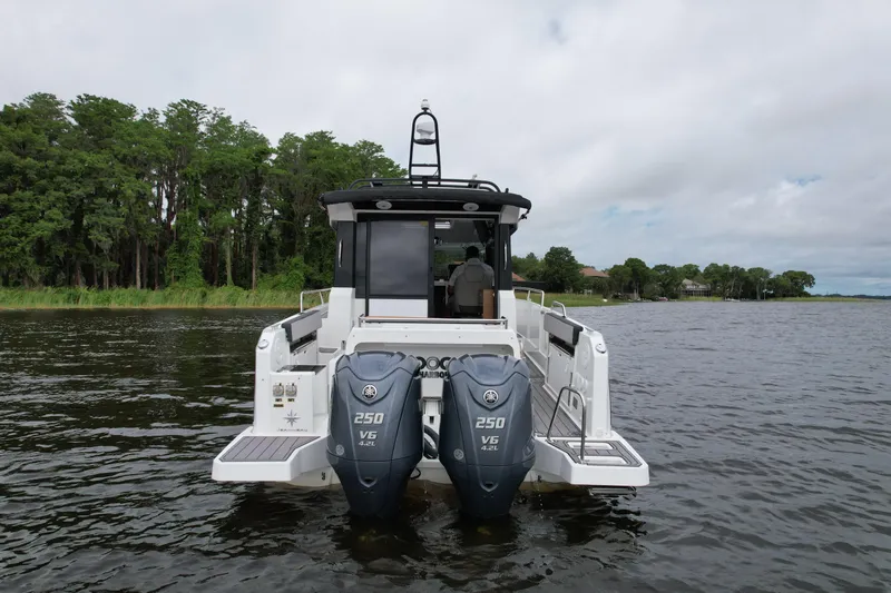  Yacht Photos Pics 2023 Jeanneau NC Sport 895 boat with dual 250 V6 engines on a lake.