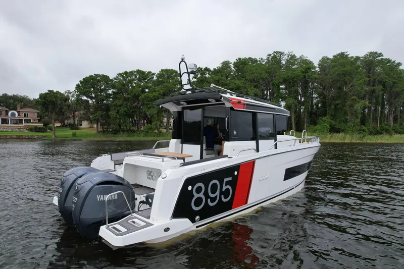  Yacht Photos Pics 2023 Jeanneau NC Sport 895 boat on water, featuring dual Yamaha engines.