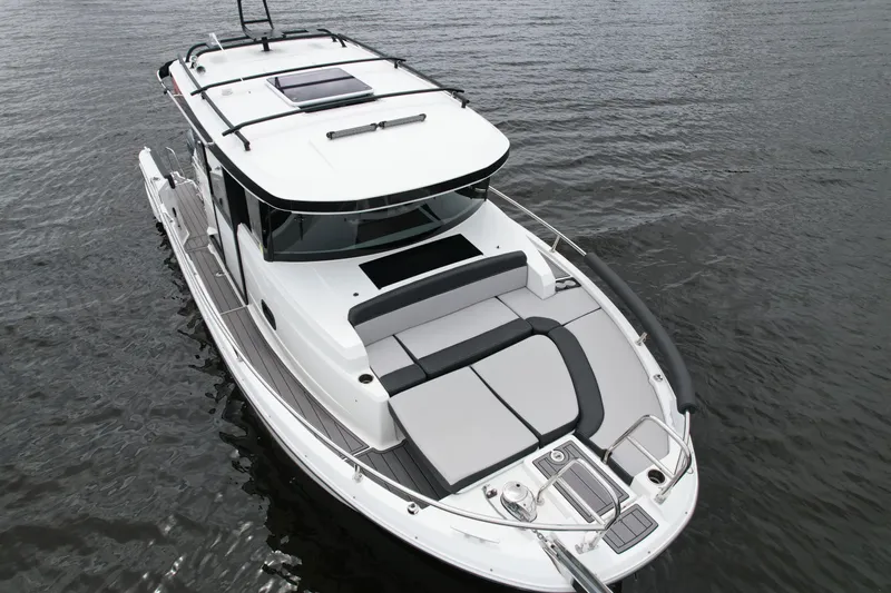  Yacht Photos Pics 2023 Jeanneau NC Sport 895 boat on water, featuring sleek design and spacious deck.
