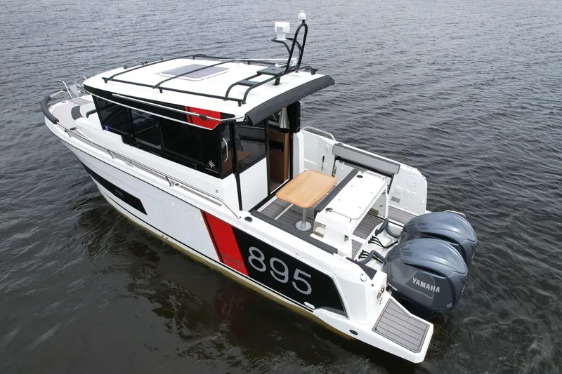  Yacht Photos Pics 2023 Jeanneau NC Sport 895 boat with twin Yamaha engines on water.