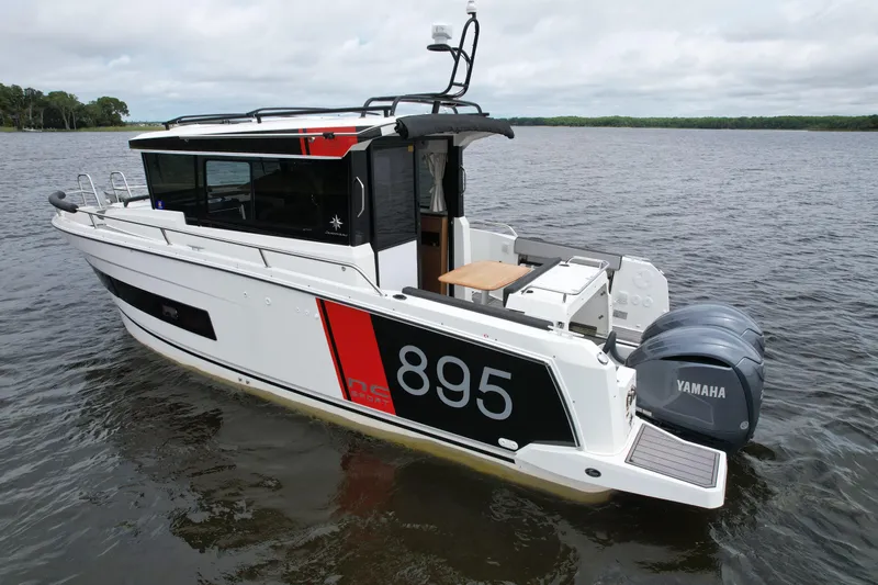  Yacht Photos Pics 2023 Jeanneau NC Sport 895 boat with Yamaha engines on a calm lake.