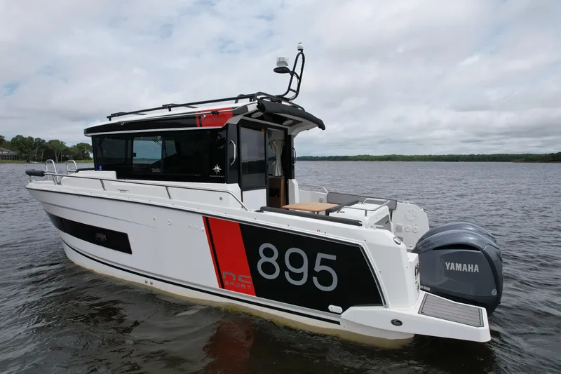  Yacht Photos Pics 2023 Jeanneau NC Sport 895 boat with Yamaha engine on calm water.